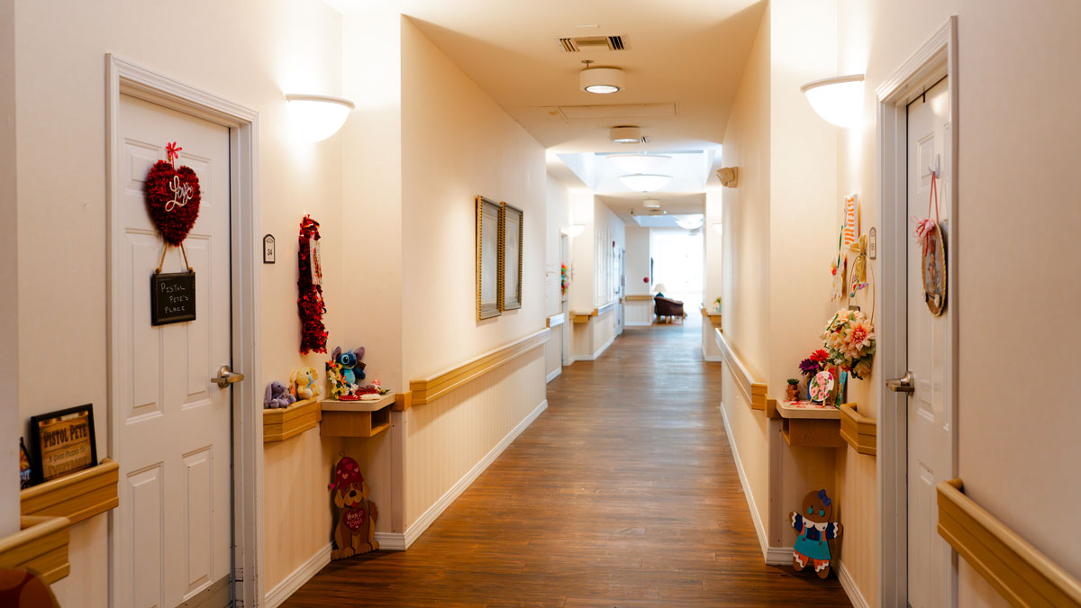 hallway in assisted living facility with decorations on doors